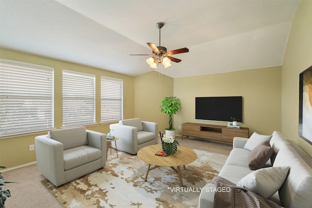 carpeted living room featuring vaulted ceiling and ceiling fan