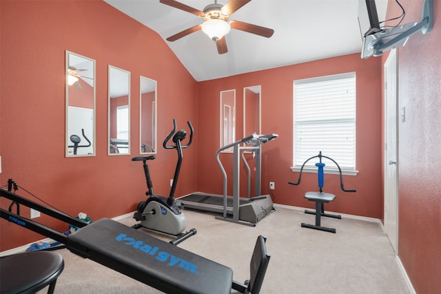 workout room featuring light colored carpet and vaulted ceiling