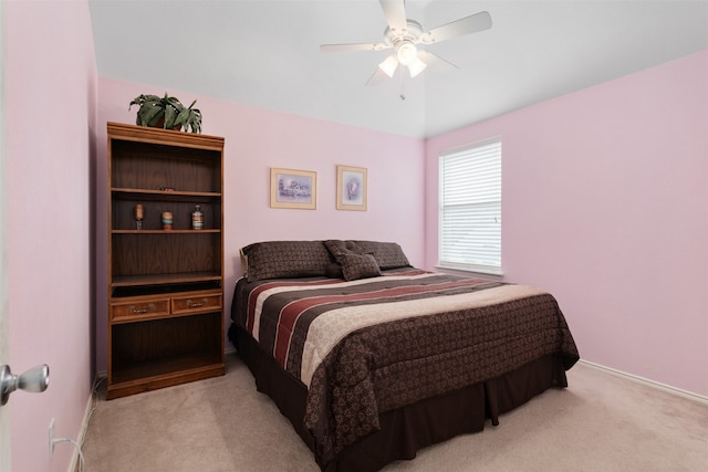 bedroom featuring light colored carpet and ceiling fan