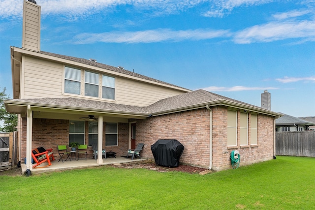 back of house featuring a patio area, ceiling fan, and a lawn