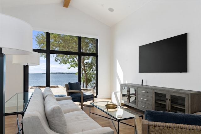 living room featuring high vaulted ceiling, a water view, hardwood / wood-style floors, and beam ceiling