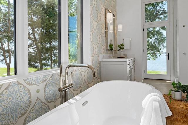 455 Sun Vly, Mabank, TX 75147 - bathroom featuring a soaking tub, vanity, and tile patterned flooring