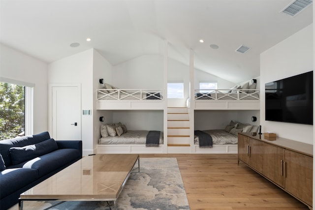 bedroom featuring light hardwood / wood-style flooring and high vaulted ceiling