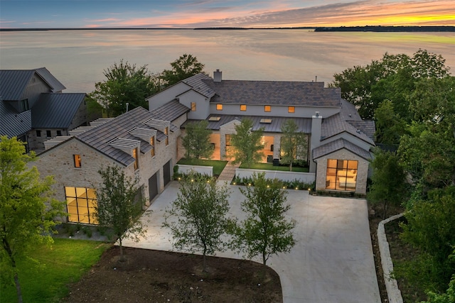 view of front of property with a garage and a water view