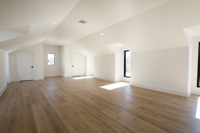 bonus room featuring hardwood / wood-style flooring and vaulted ceiling