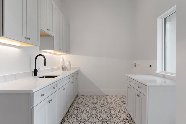 kitchen featuring sink and light tile patterned flooring