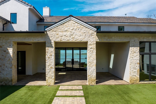 455 Sun Vly, Mabank, TX 75147 - back of house with stone siding, stucco siding, a lawn, and a chimney