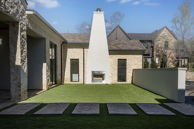 455 Sun Vly, Mabank, TX 75147 - rear view of property featuring a chimney, a yard, stone siding, and stucco siding