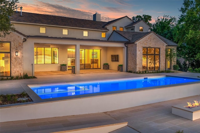 455 Sun Vly, Mabank, TX 75147 - rear view of house featuring a patio, an outdoor pool, and a fire pit