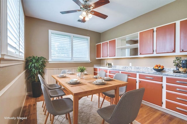 dining room with light hardwood / wood-style floors and ceiling fan