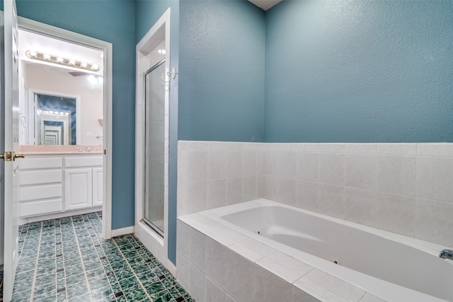 bathroom featuring vanity, tile patterned flooring, and separate shower and tub