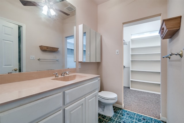 bathroom with ceiling fan, vanity, and toilet