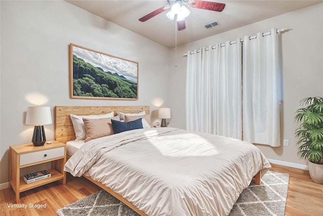 bedroom featuring light hardwood / wood-style floors and ceiling fan