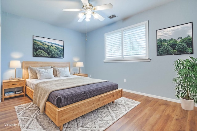 bedroom with ceiling fan and light wood-type flooring