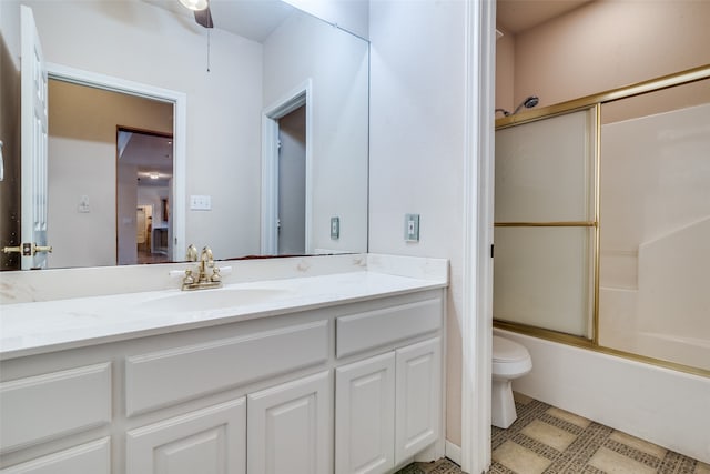 full bathroom featuring shower / bath combination with glass door, vanity, toilet, and ceiling fan