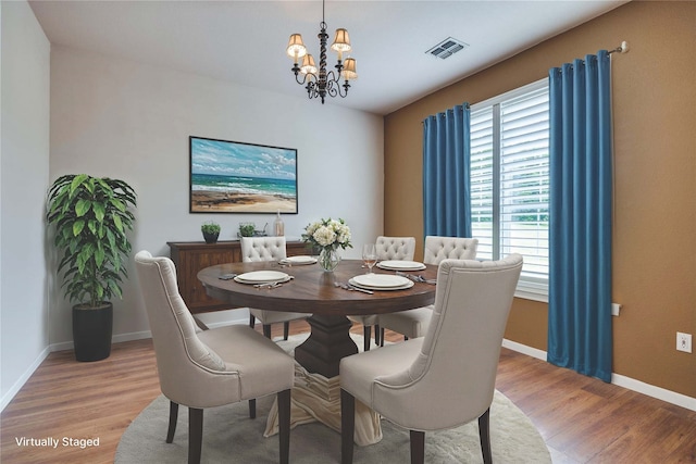 12228 Saddle Club Dr, Forney, TX 75126 - dining area with baseboards, a chandelier, visible vents, and light wood-style floors
