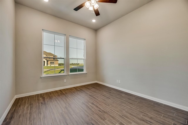 spare room featuring dark hardwood / wood-style floors and ceiling fan