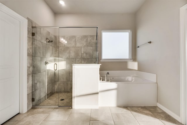 bathroom with tile patterned flooring and independent shower and bath