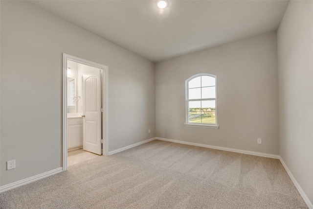 unfurnished room with light carpet