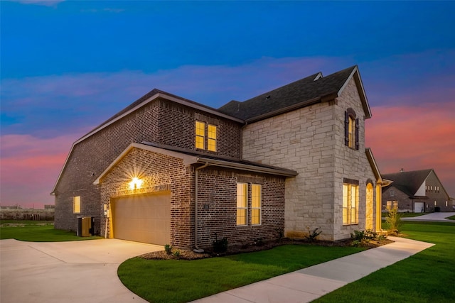 view of front facade with a yard and a garage