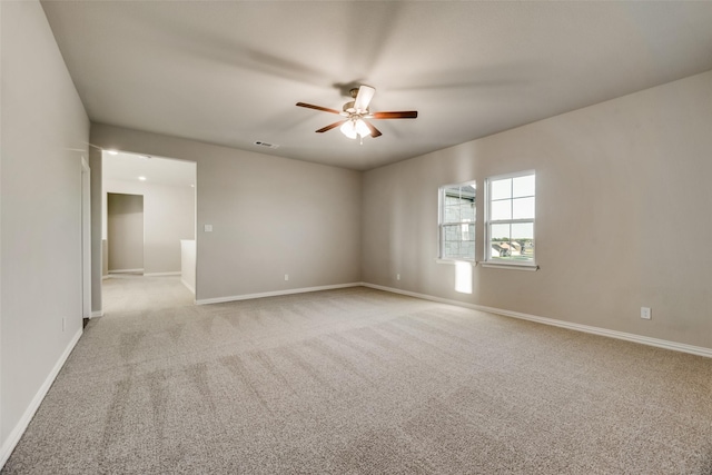 empty room with ceiling fan and light colored carpet