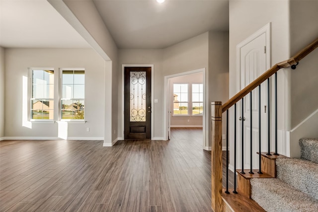 entryway with hardwood / wood-style flooring and a healthy amount of sunlight