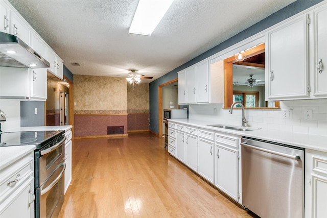 kitchen featuring white cabinetry, sink, backsplash, a textured ceiling, and appliances with stainless steel finishes