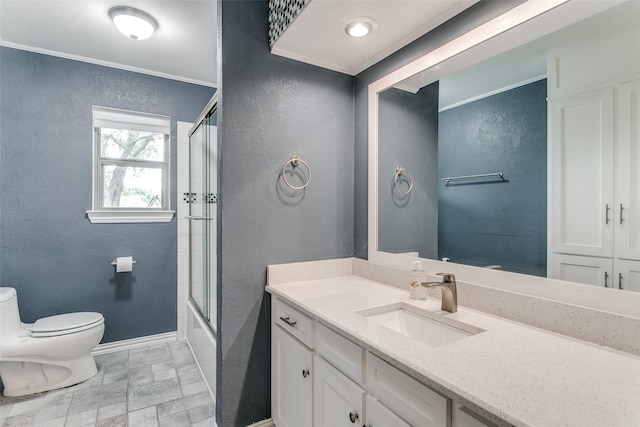 full bathroom featuring shower / bath combination with glass door, vanity, toilet, and crown molding