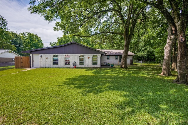 rear view of property with a yard