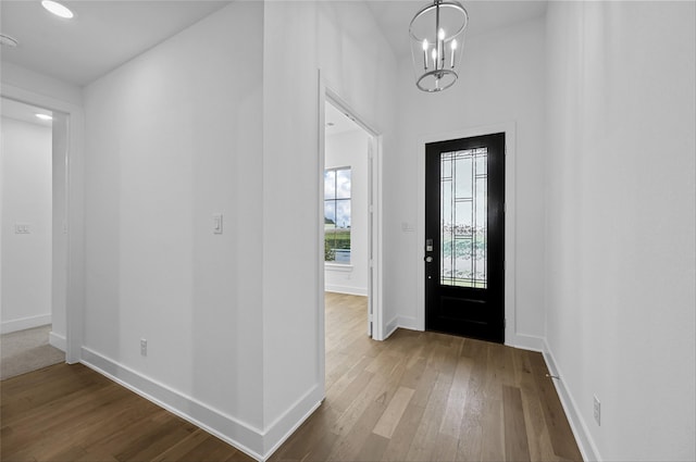 entrance foyer with a notable chandelier and wood-type flooring