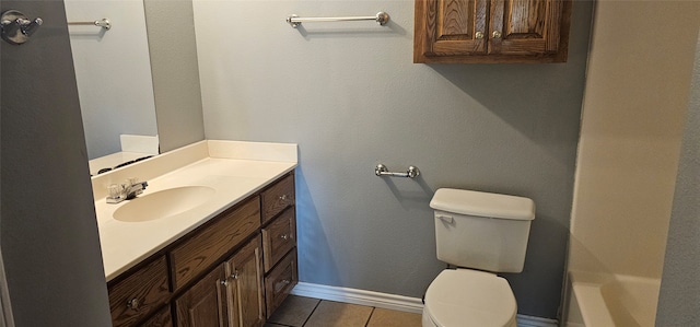 bathroom with tile floors, toilet, and vanity