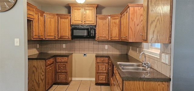 kitchen with sink, tasteful backsplash, and light tile floors