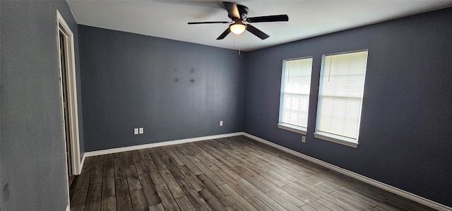 empty room featuring a healthy amount of sunlight, dark hardwood / wood-style floors, and ceiling fan