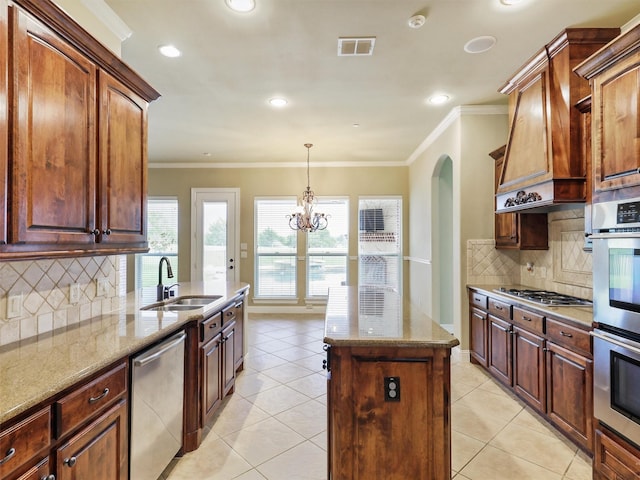 kitchen with light stone counters, stainless steel appliances, sink, light tile patterned floors, and an inviting chandelier