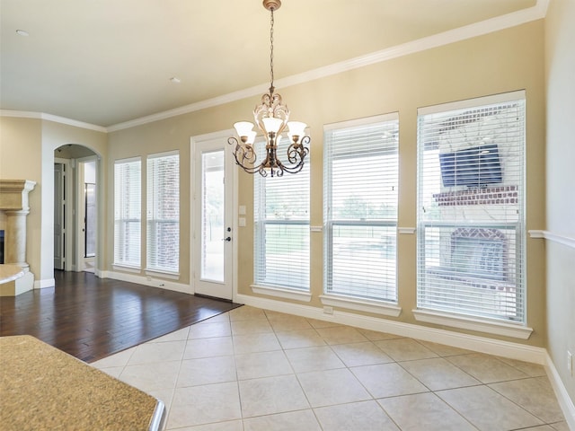 unfurnished dining area with light hardwood / wood-style flooring, a notable chandelier, and ornamental molding