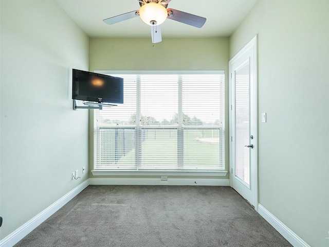 carpeted empty room with plenty of natural light and ceiling fan