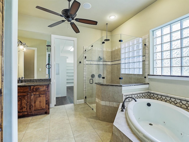 bathroom with plus walk in shower, vanity, ceiling fan, and tile patterned flooring