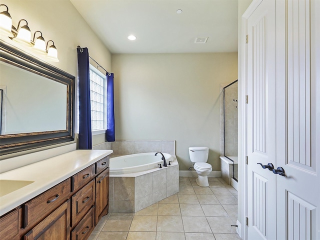 full bathroom with tile patterned flooring, shower with separate bathtub, vanity, and toilet