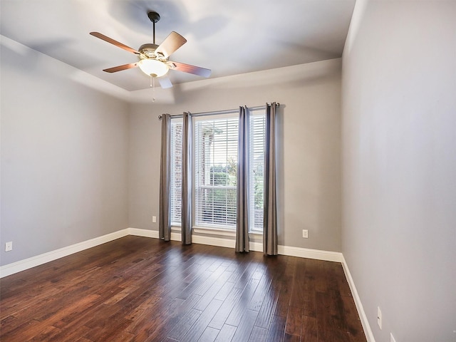 empty room featuring ceiling fan and dark wood-type flooring