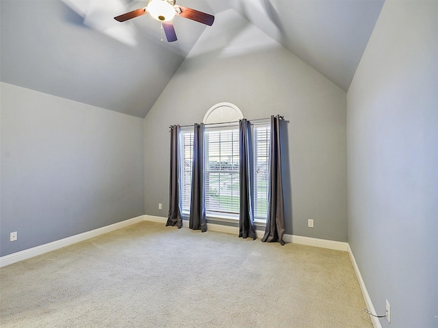 empty room featuring ceiling fan, light carpet, and high vaulted ceiling