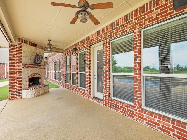 view of patio / terrace with an outdoor stone fireplace and ceiling fan