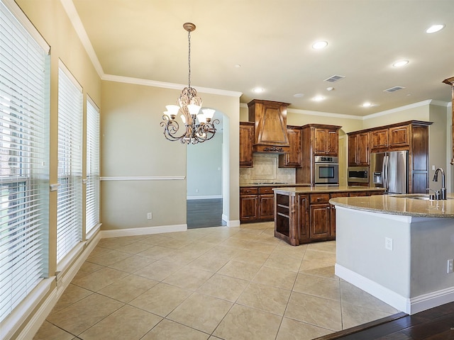 kitchen with stainless steel appliances, premium range hood, ornamental molding, and sink