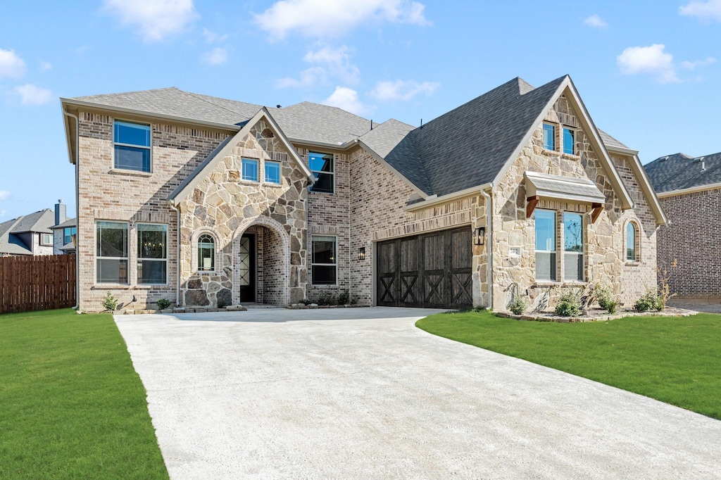 view of front facade with a garage and a front lawn