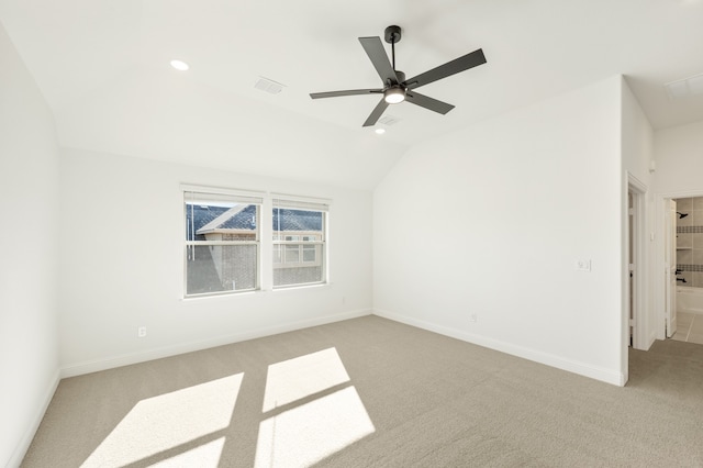 spare room featuring lofted ceiling, light carpet, and ceiling fan