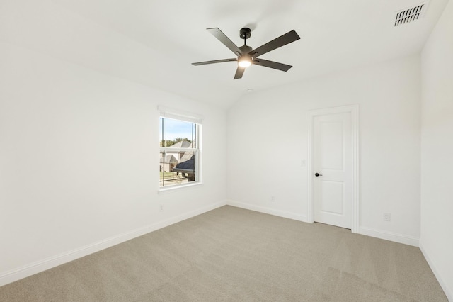 carpeted empty room with ceiling fan and lofted ceiling