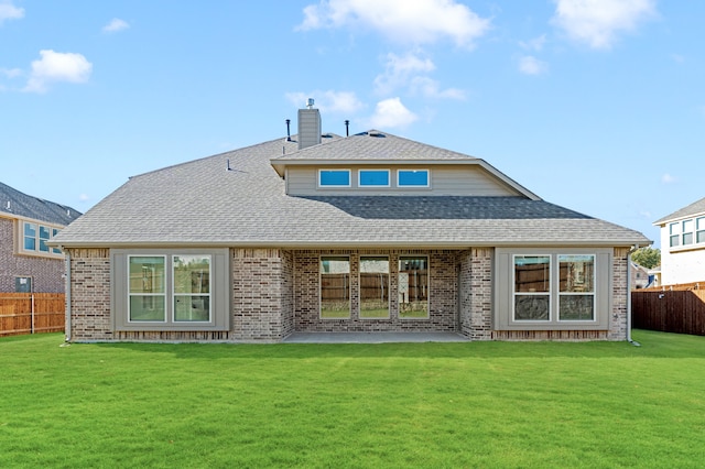 rear view of property with a yard and a patio