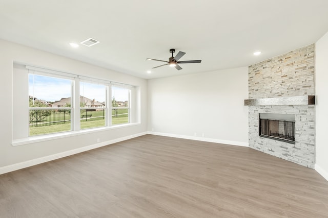 unfurnished living room with ceiling fan, hardwood / wood-style flooring, and a fireplace