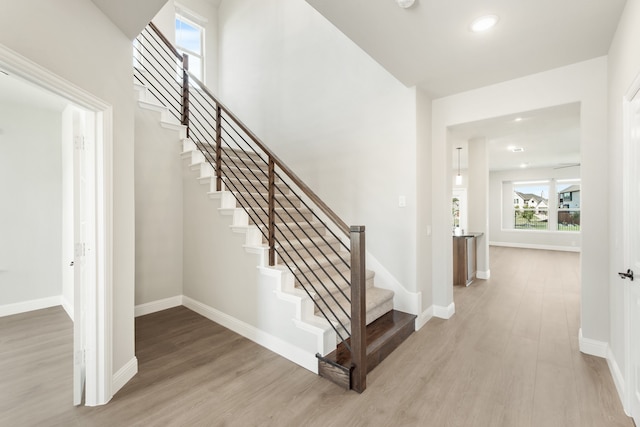 stairs featuring hardwood / wood-style flooring