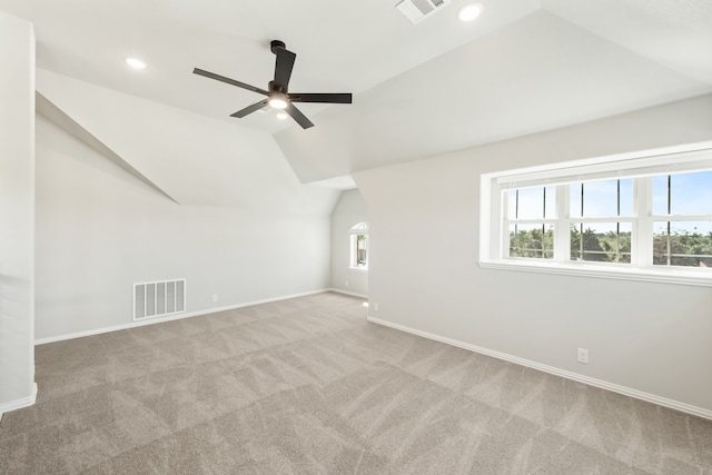 additional living space with vaulted ceiling, ceiling fan, and light carpet