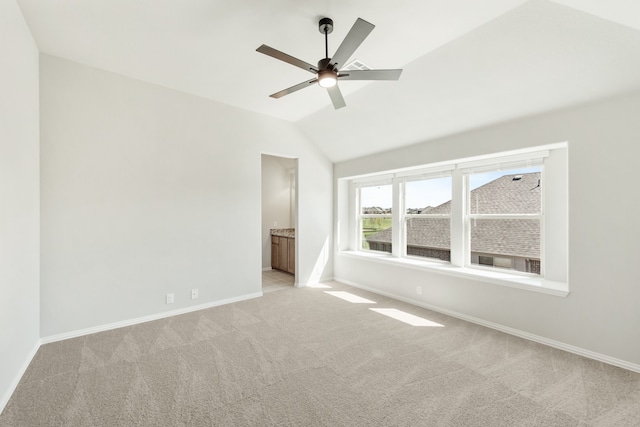 interior space featuring light carpet, vaulted ceiling, and ceiling fan